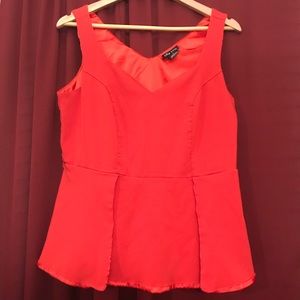 Peplum Top In Tangelo